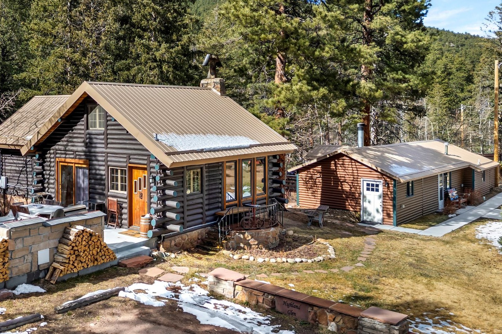 Old Seven River Camp: the flagship log cabin and a second cabin set among the pines along the St. Vrain