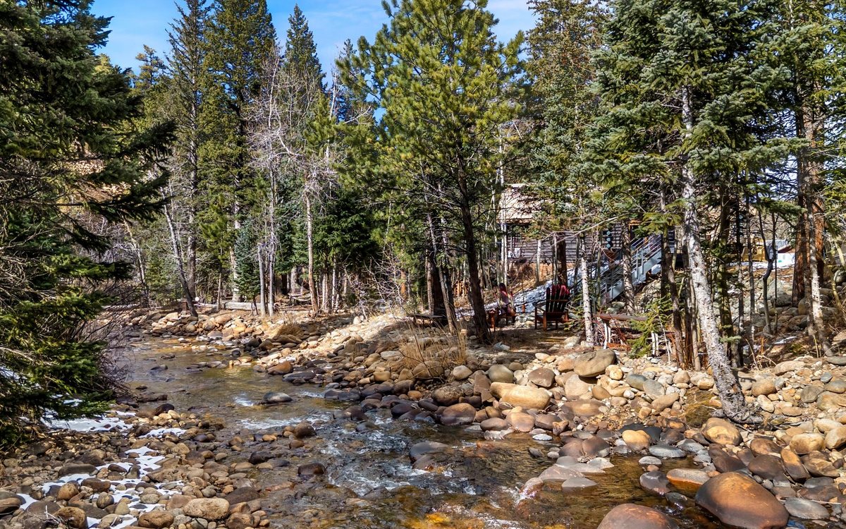 The St. Vrain running clear over granite boulders along the property