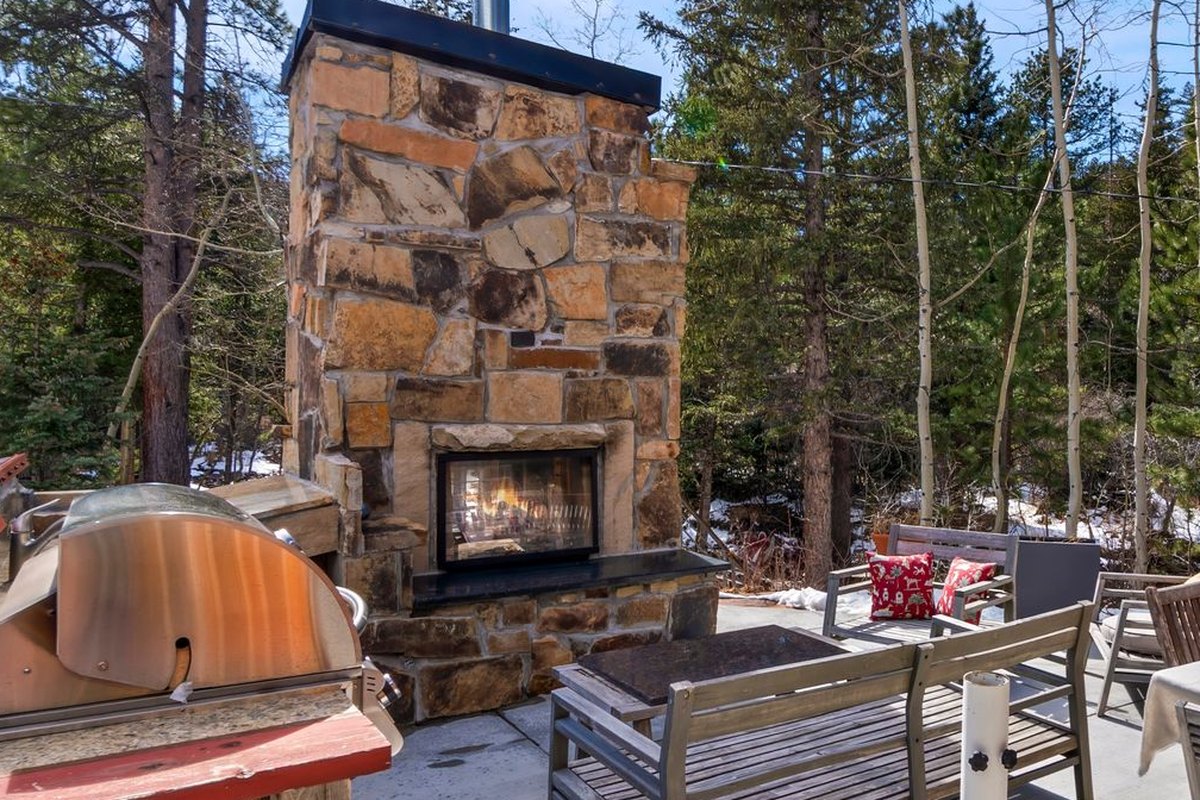 The stone fireplace terrace and the staircase down toward the river