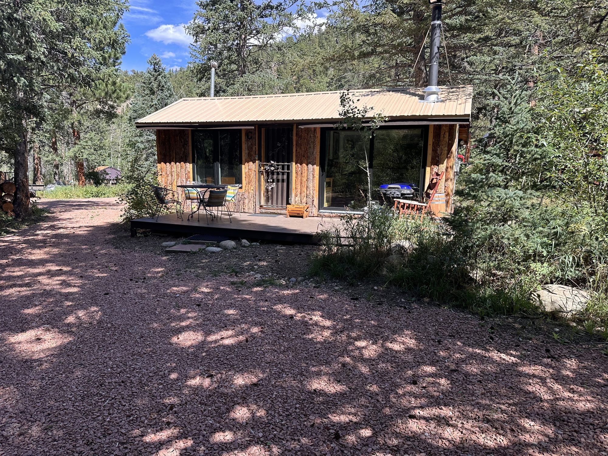 The Riffle, a contemporary cabin with a wall of glass and a river-facing deck