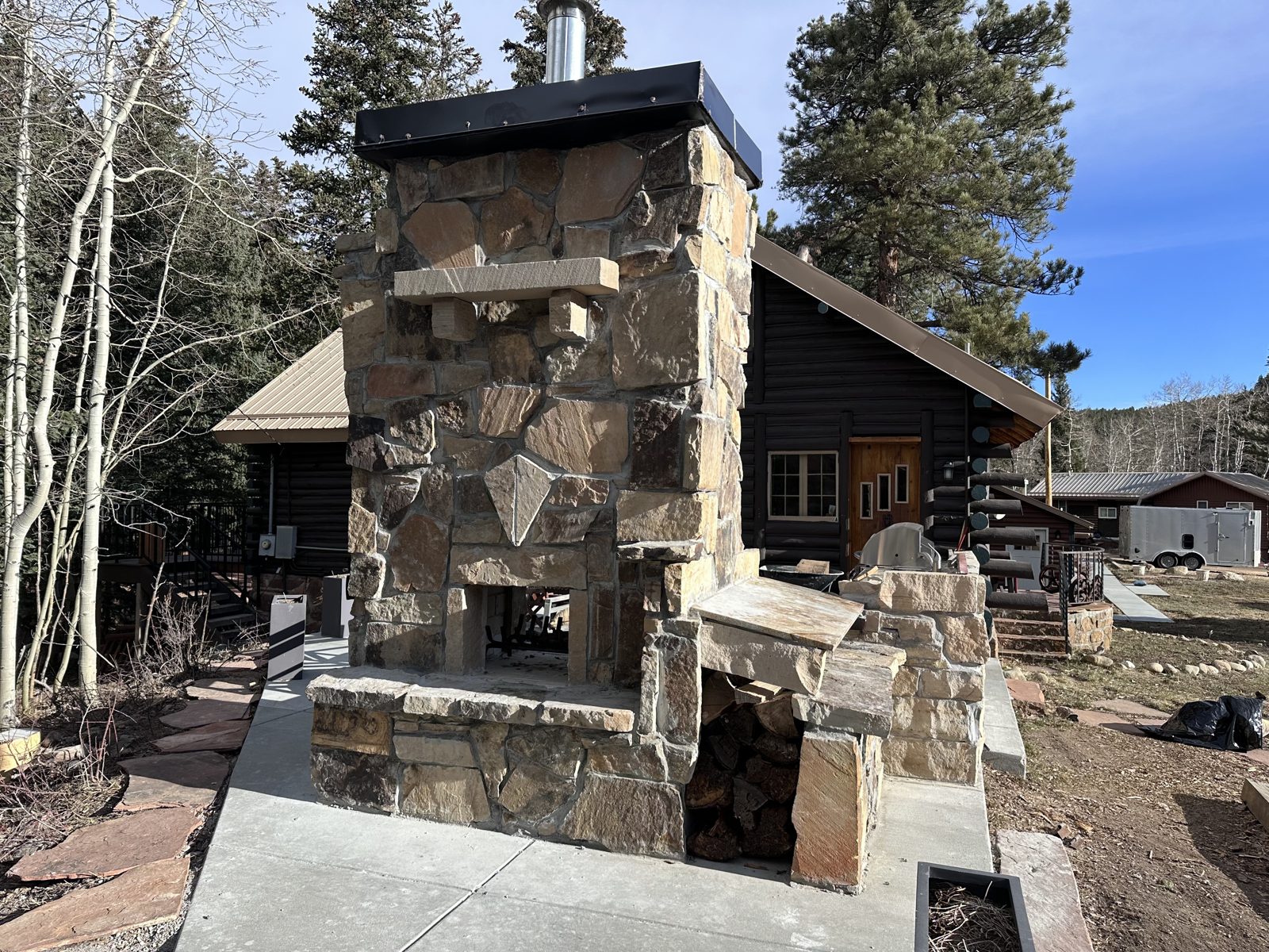 The outdoor stone fireplace on the terrace beside The Schaeffer