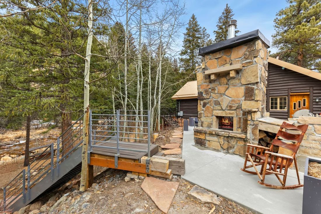 The stacked-stone outdoor fireplace and dining terrace